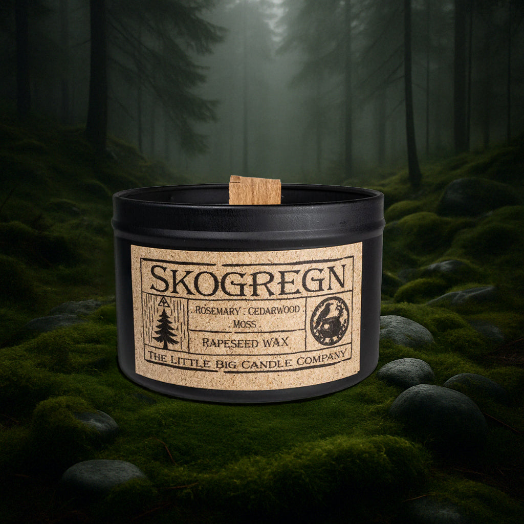 Skogregn candle in black matte tin, rapeseed wax, rosemary and cedarwood fragrance, inspired by Scandinavian forest rain.
